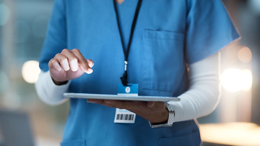 close up of a nurse using a tablet